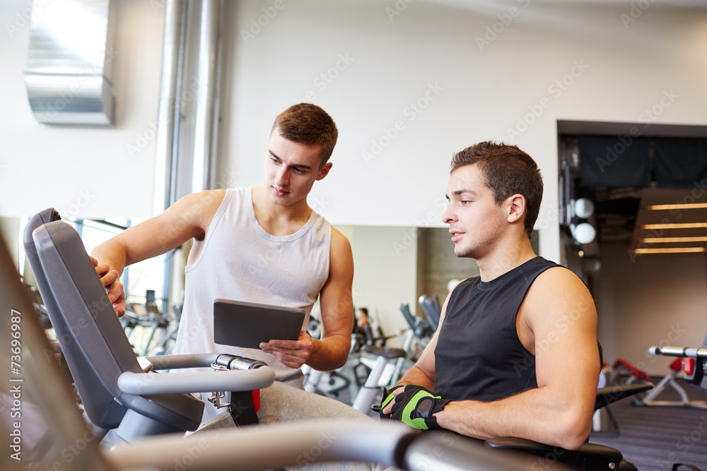 men exercising on gym machine men exercising on gym machine