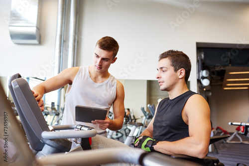 men exercising on gym machine