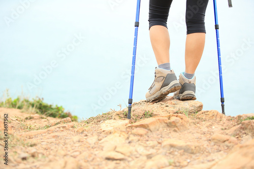 hiking feet stand at seaside mountain peak rock