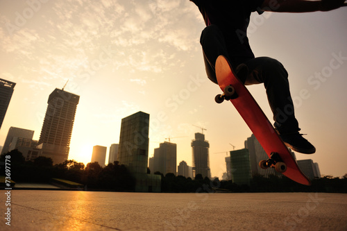 woman skateboarder skateboarding at sunrise city