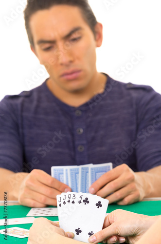 young man playing cards cuarenta traditional Ecuadorian game