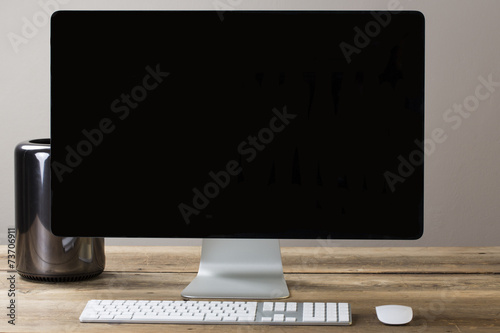 big computer screen with stationary items
