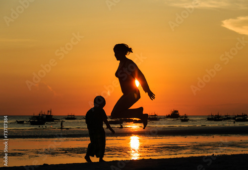 famiy jumping at sunset photo