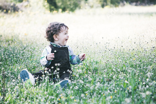 The child in the field during a sunset photo