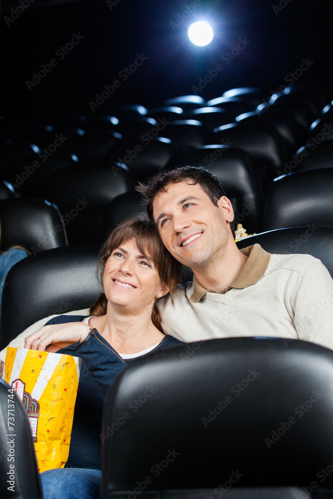 Fototapeta premium Happy Loving Couple Watching Film In Theater