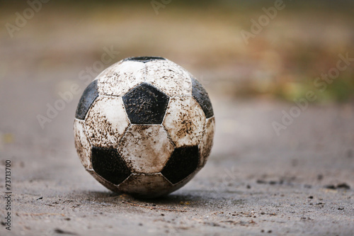 Soccer ball on ground in rainy day, outdoors © Africa Studio