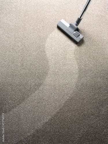 Vacuum cleaner on a carpet with a extra clean strip