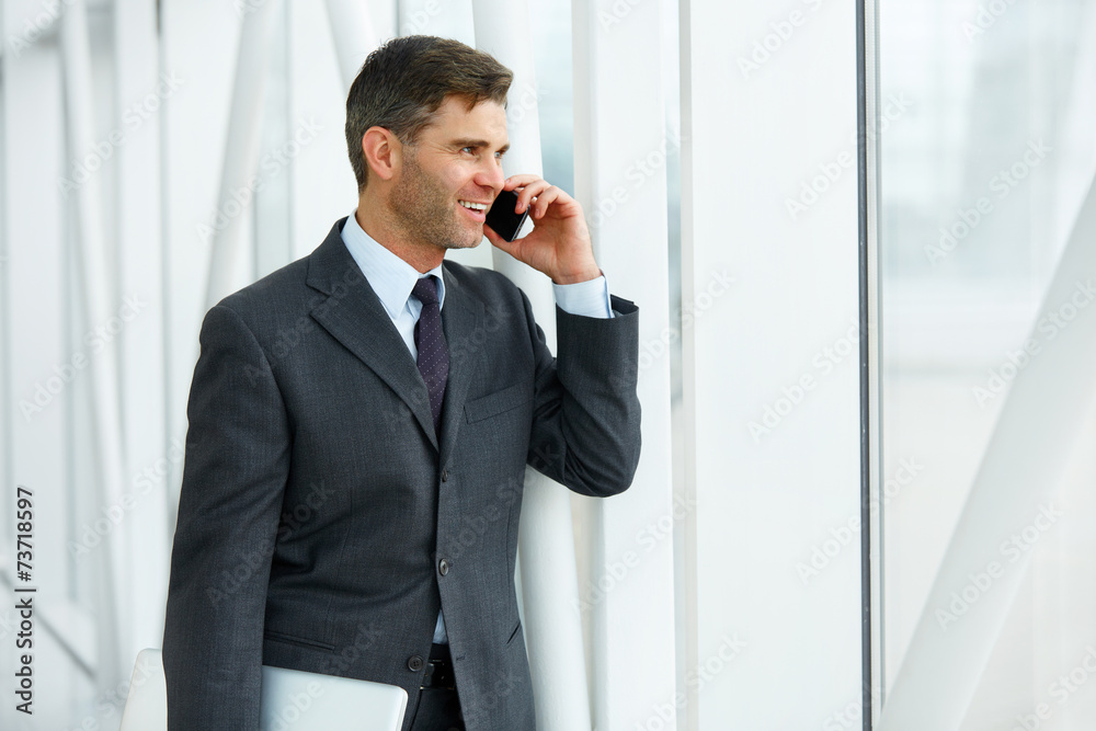 Smiling Business Man Talking on Mobile Phone Smiling Business Man Talking on Mobile Phone