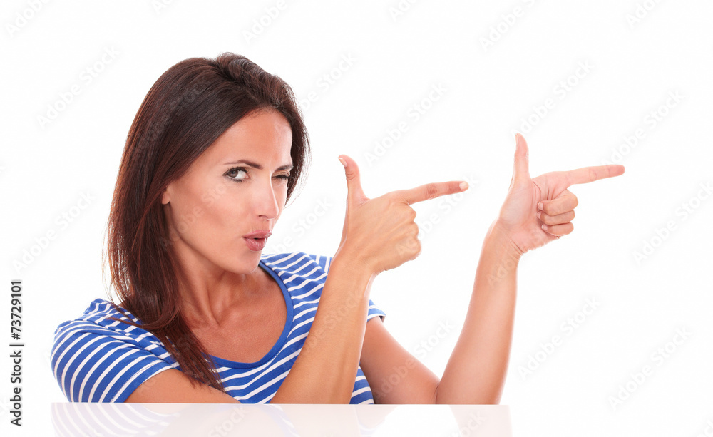 Attractive winking woman pointing to her left Attractive winking woman pointing to her left