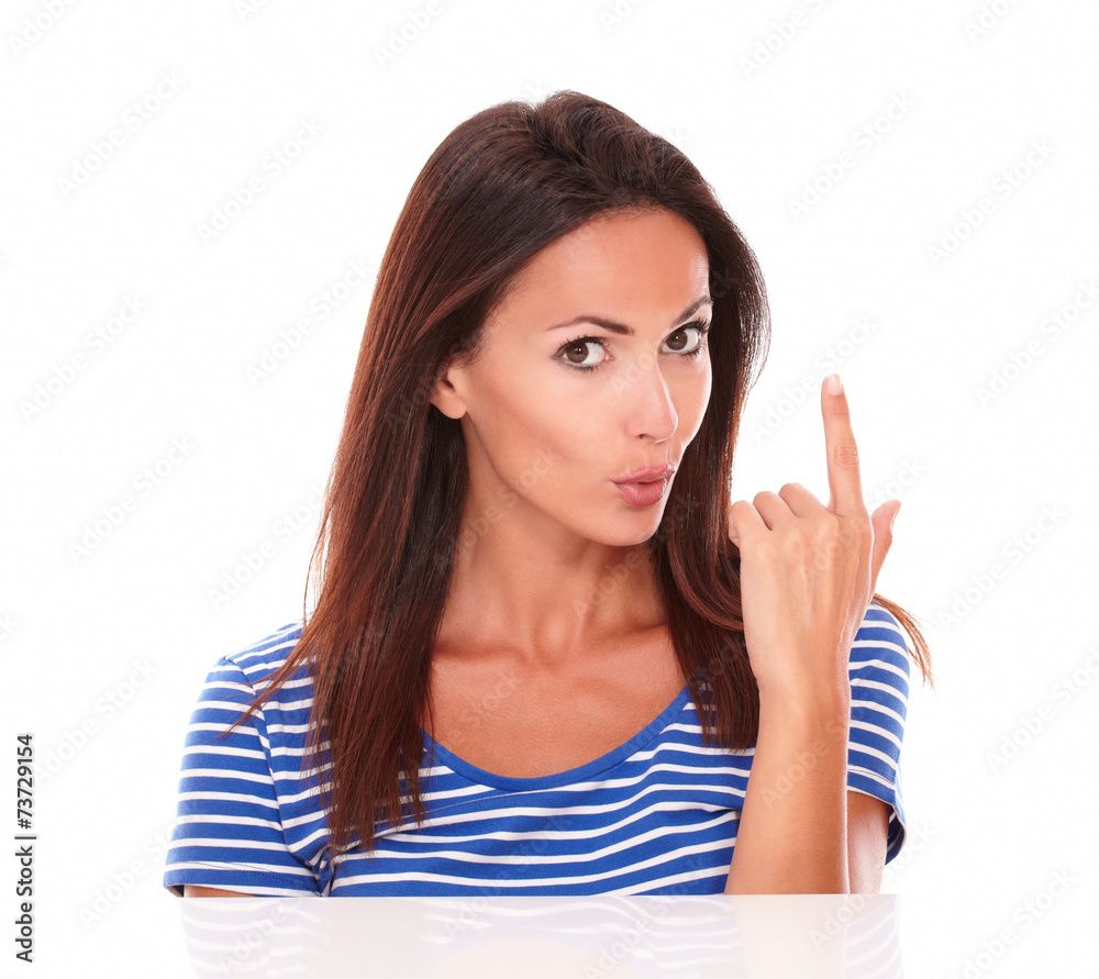 Fashionable friendly hispanic female pointing up Fashionable friendly hispanic female pointing up
