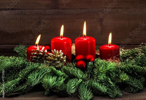 advent decoration with four red burning candles