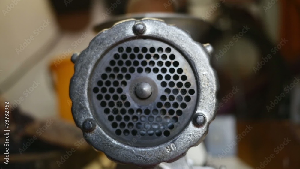 Meat grinder grinding meat in slow motion Meat grinder grinding meat in slow motion