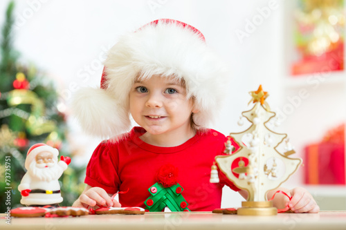 child girl in Santa hat wit...