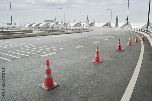 Traffic cone placed on the curving road