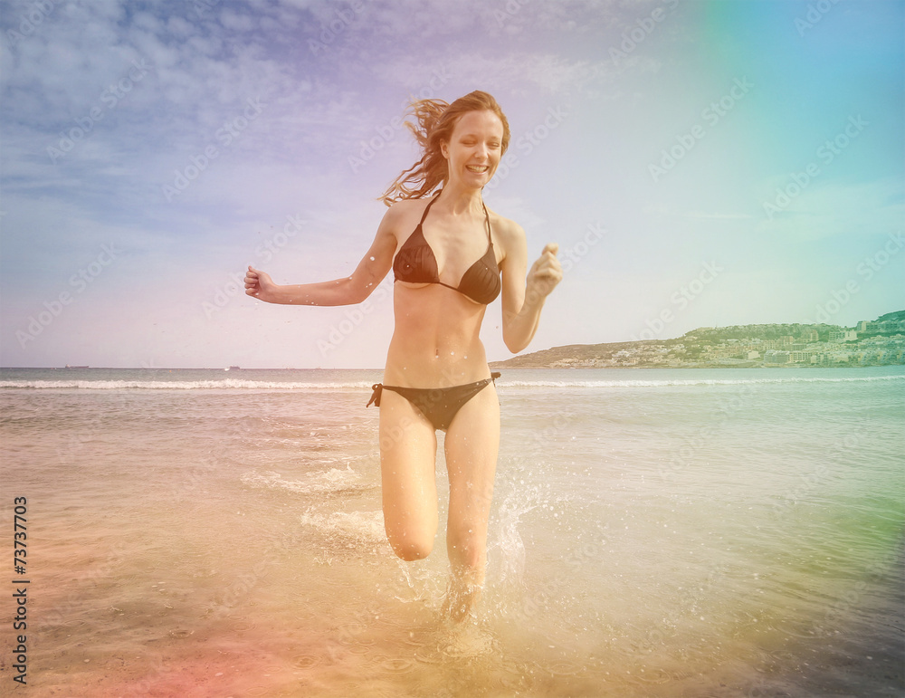 Naklejka premium Girl running in the water