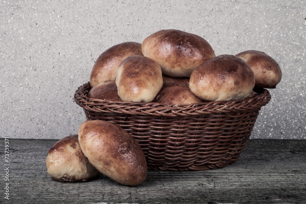 pies with meat or cabbage in a wicker basket on a wooden backgro pies with meat or cabbage in a wicker basket on a wooden backgro