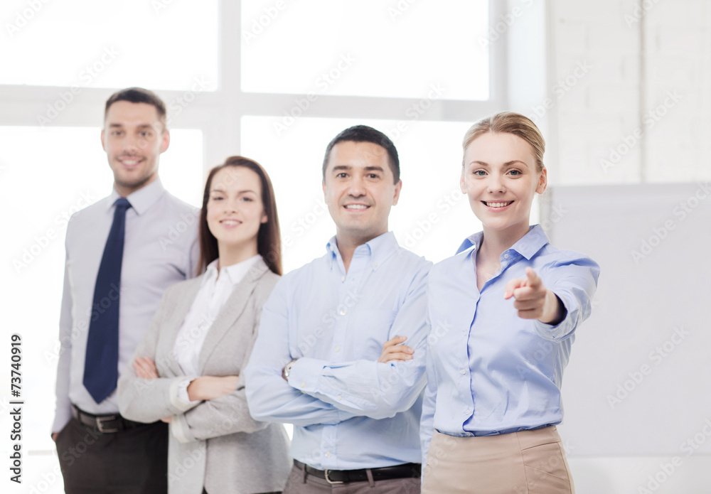 businesswoman in office pointing finger at you businesswoman in office pointing finger at you