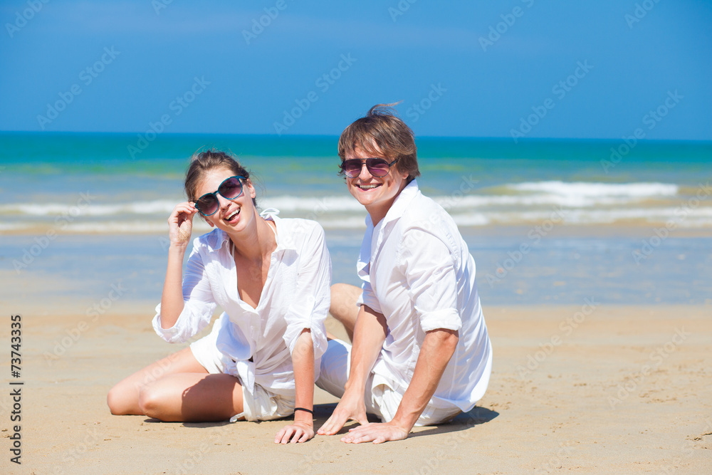 young happy couple having fun on tropical beach. honeymoon young happy couple having fun on tropical beach. honeymoon
