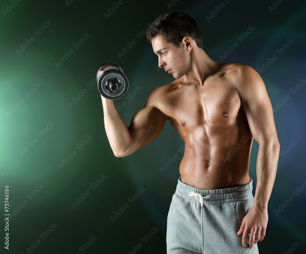 young man with dumbbell flexing biceps young man with dumbbell flexing biceps