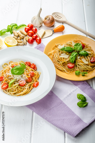 Lemon pasta with cherry tomatoes, basil and nuts