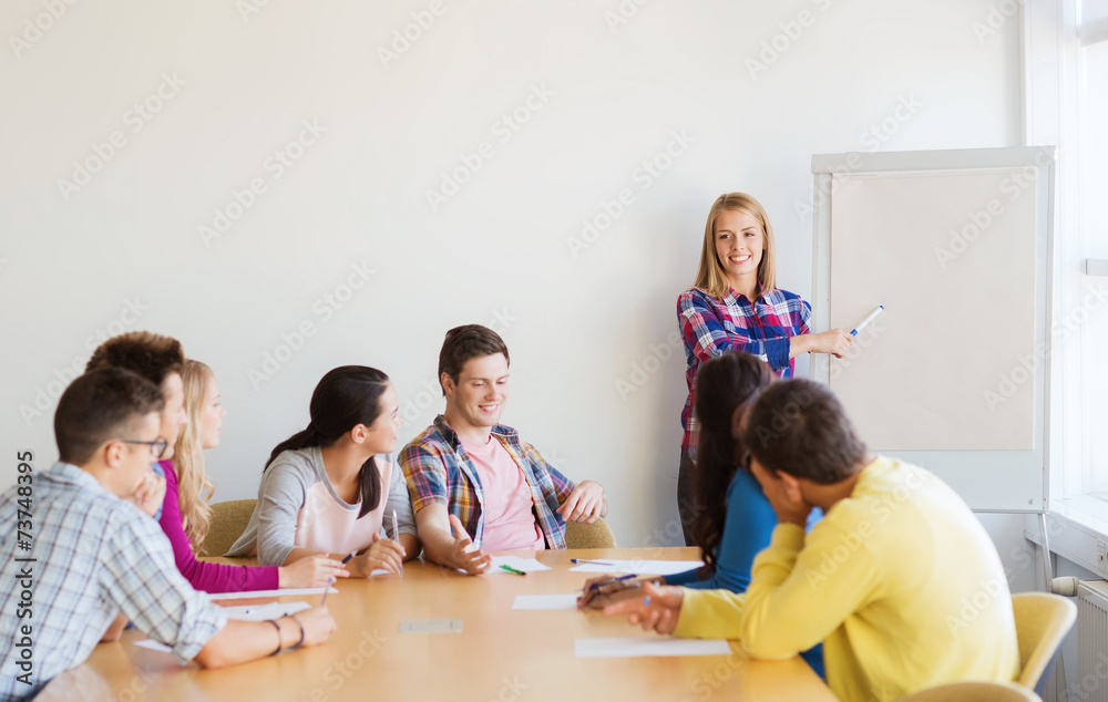 group of smiling students with white board group of smiling students with white board