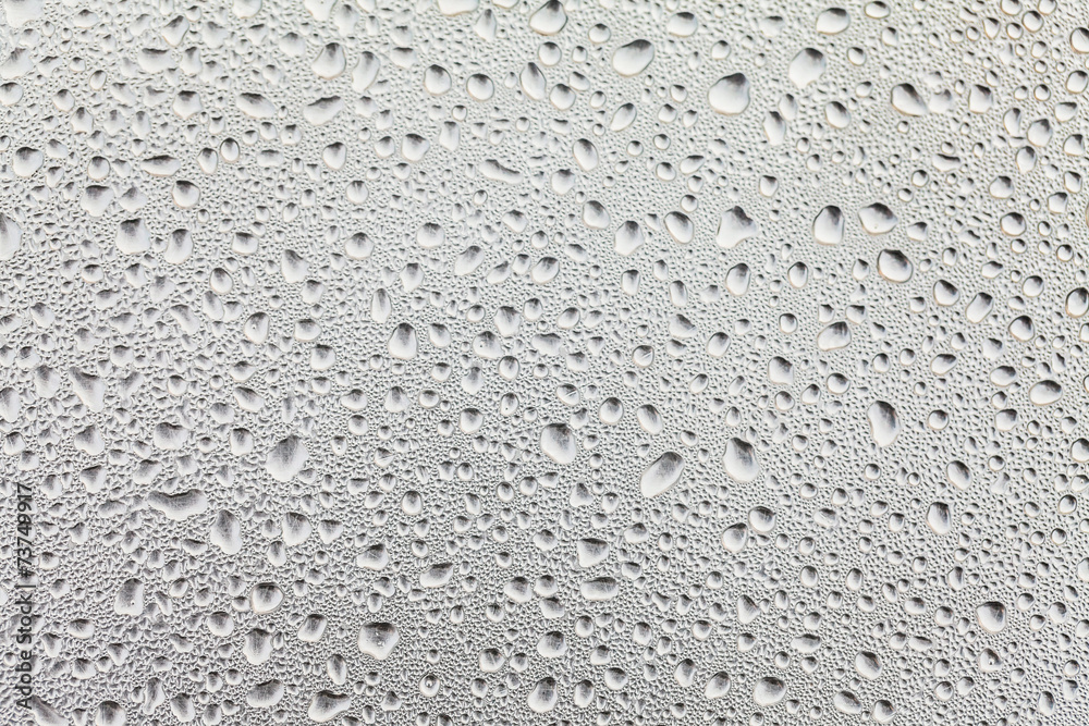 Metal surface covered in water drops.
