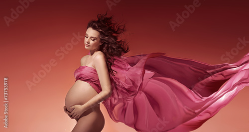 Amazing pregnant woman touching her belly