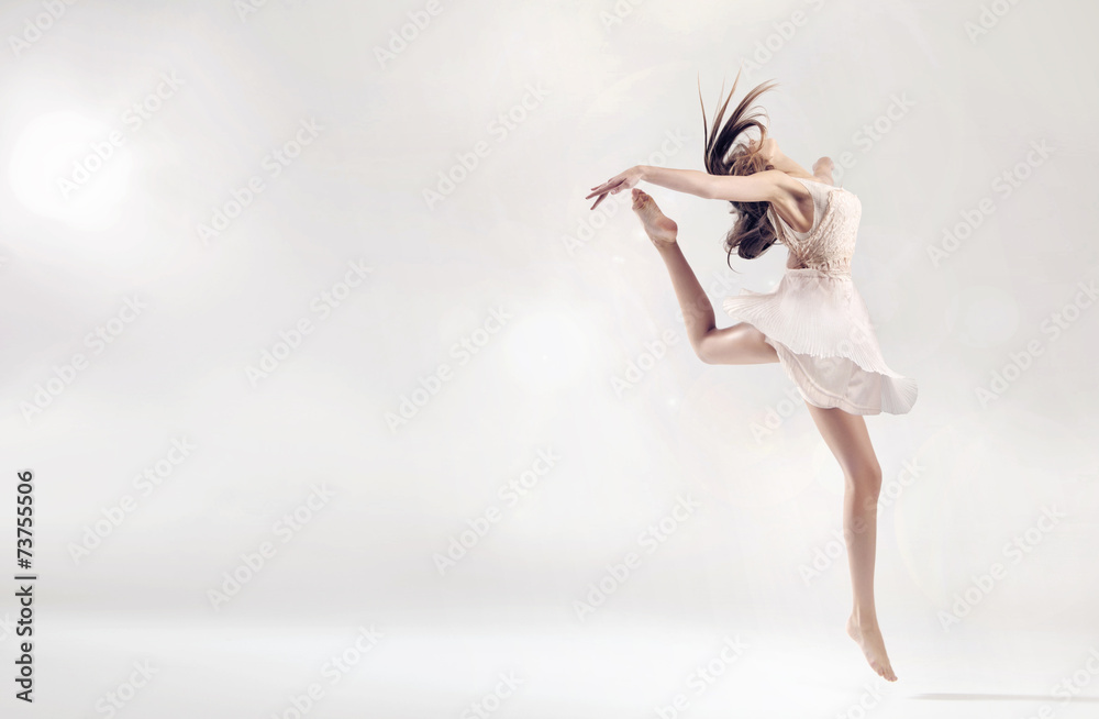 Pretty female ballet dancer in jump figure