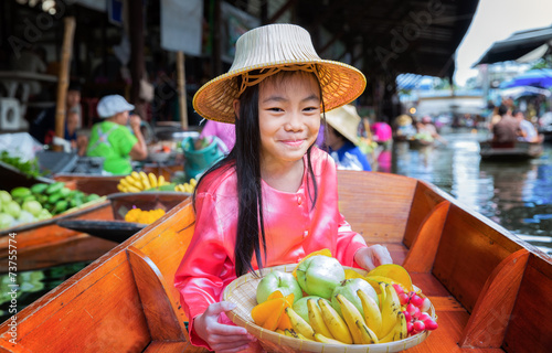 Photography Child sit on the boat and hold the fruit basket