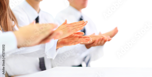 Close-up of business people clapping hands.