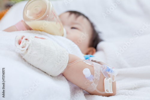 Little asian girl lying  on a medical bed