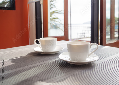 Fototapeta Naklejka Na Ścianę i Meble -  Coffee cup on table morning in restaurant cafe