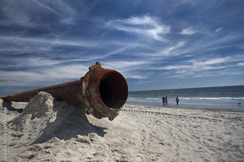 rusty pipes along the sea beach rusty pipes along the sea beach