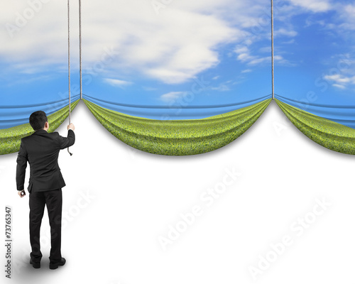 businessman pulling open natural sky meadow curtain revealed bla
