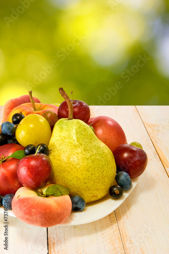 different fruits on a plate on a blurred background