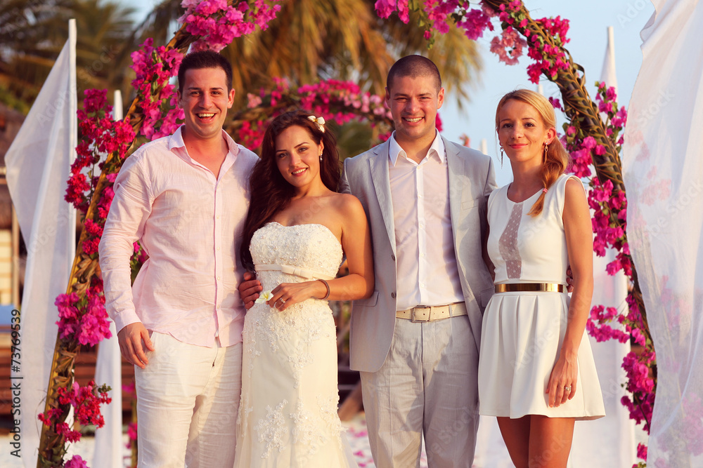 Obraz premium beautiful bride and groom with friends