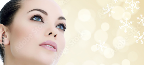 Pretty woman against an abstract background with snowflakes