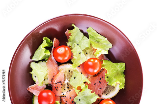 Appetizing fish salad with vegetables on plate isolated on