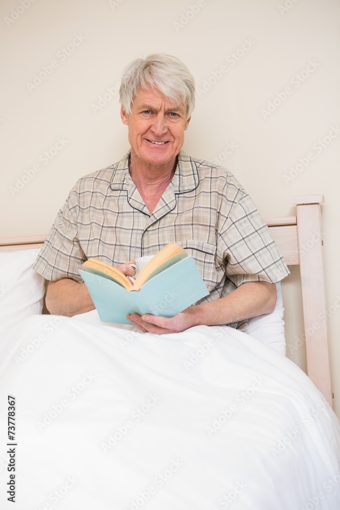 Senior man reading a book in bed Senior man reading a book in bed