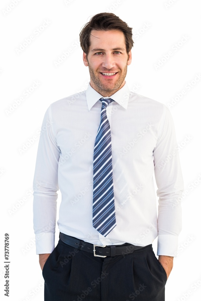 Smiling businessman standing with hands in pockets Smiling businessman standing with hands in pockets