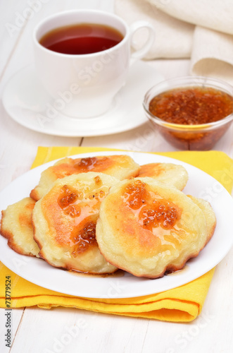 Cheese pancakes, confiture and tea cup