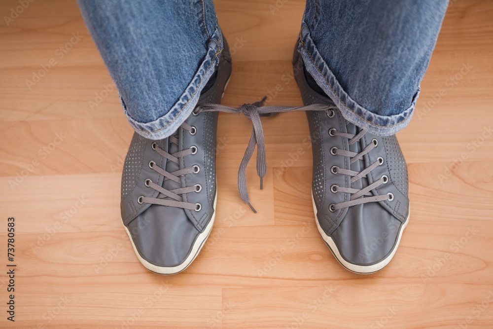 Casual mans shoelaces tied together Casual mans shoelaces tied together