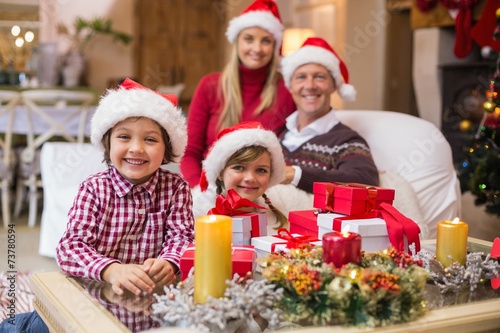 Portrait of a festive family in santa hat