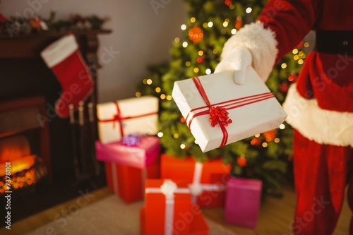 Bilde på lerret Mid section of santa delivering presents
