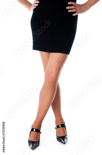 Legs of a woman in black dress