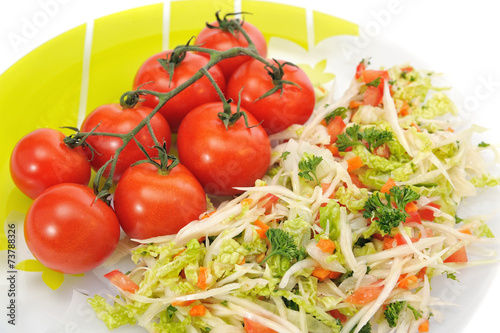 cabbage salad and tomatoes on a white background