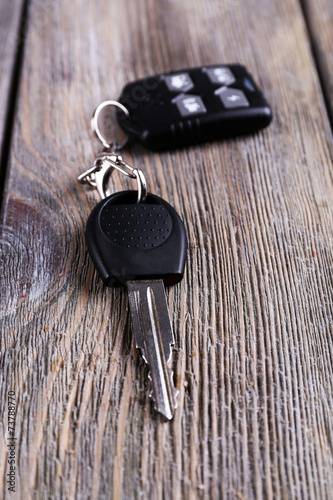 Fotografia Car key with remote control on wooden table, close-up