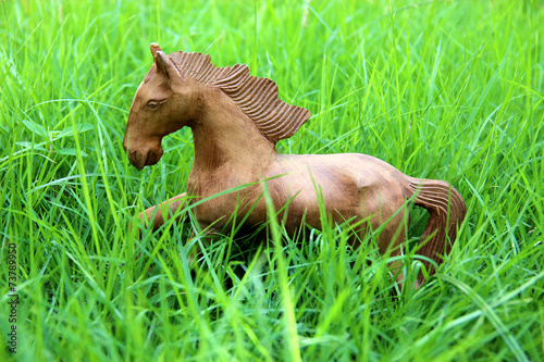 Wood horse on grass field photo