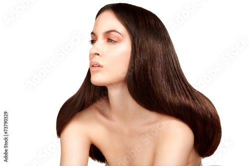 Beauty model showing perfect skin and long healthy brown hair