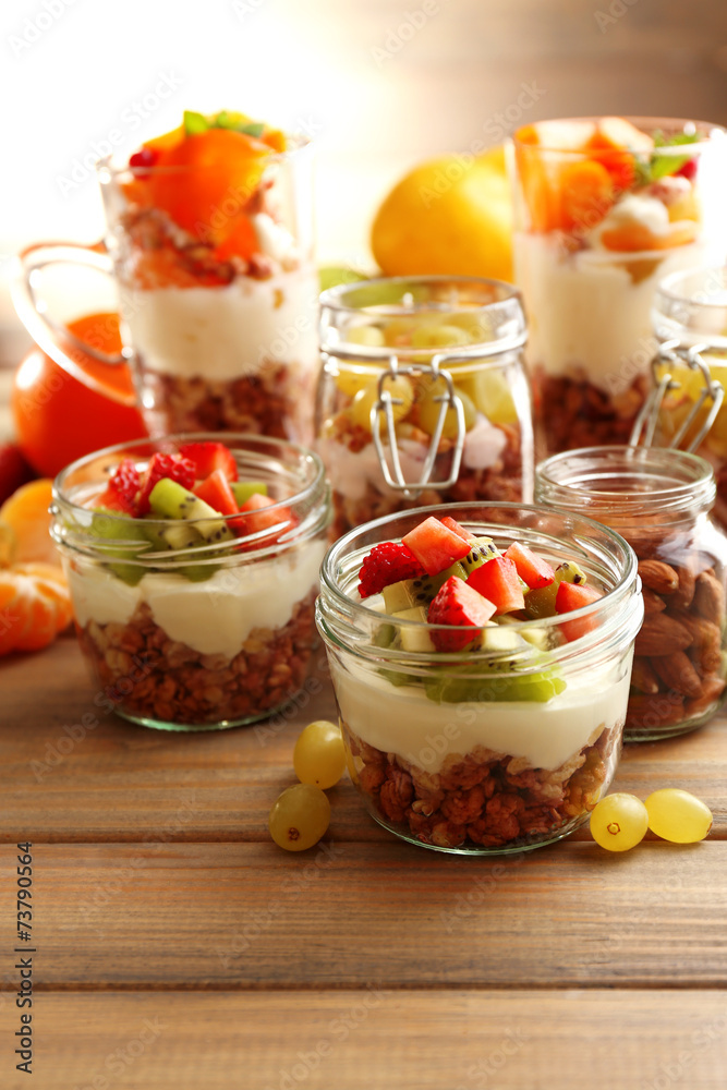 Healthy layered desserts with muesli and fruits on table Healthy layered desserts with muesli and fruits on table